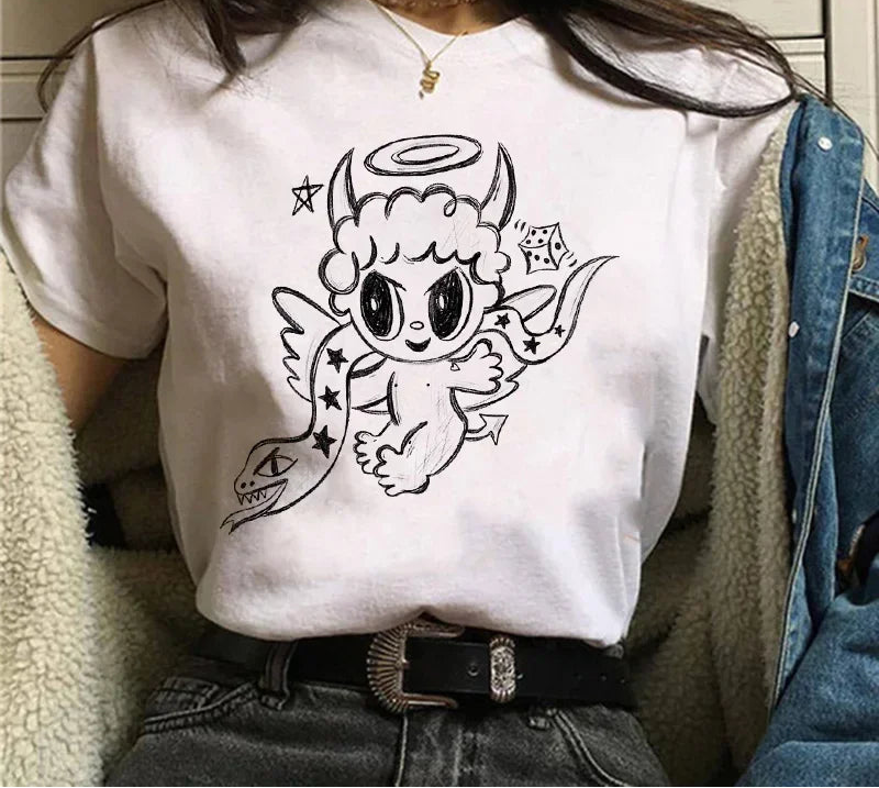 Person wearing a white t-shirt with a black graphic design of a creature with horns and wings.